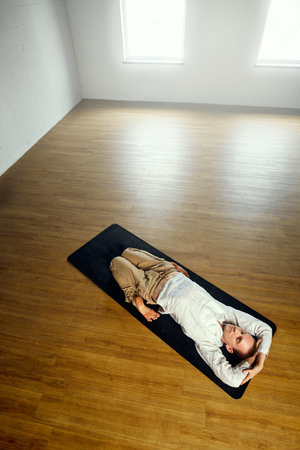 The yogi man do supta vadjrasana. Yoga practice in the studio.