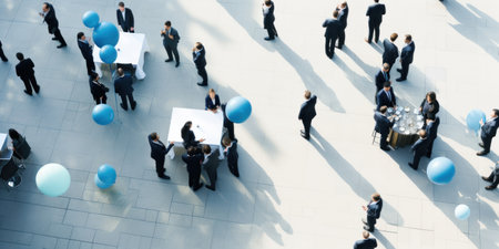 Professionals mingle at a corporate event.の素材