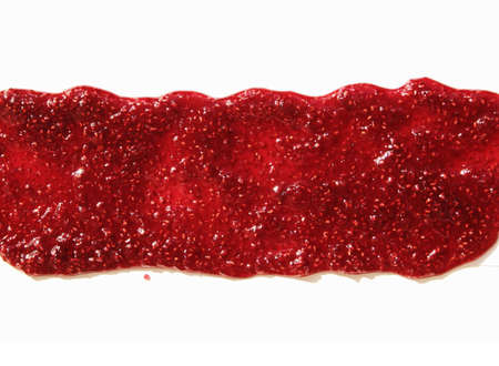 Track of  raspberry jam isolated on white background. Splashes and spilled blackberry sauce. Blots of bramble jam dipped in sauce. isolated on white background. flat lay top view.の写真素材