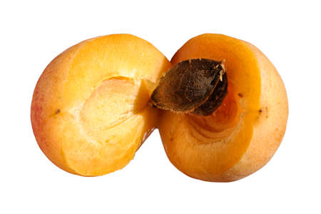 Ripe fresh apricot fruit halved isolated on white background.の写真素材