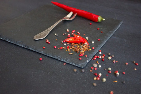 Red pepper on a fork. Sharp spices