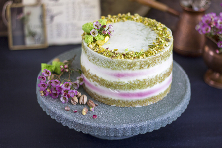 Raspberry cake with pistachio on a dark backgroundの写真素材