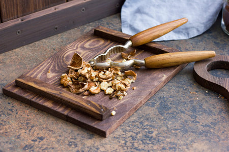 Chopped walnuts on a wooden board. Nutcracker