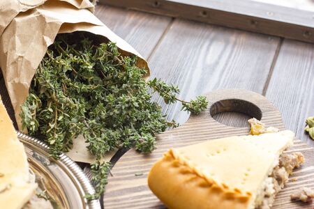 A bunch of thyme grass on a wooden table. Seasonings for meatの写真素材