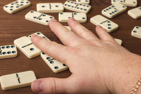 Dominoes on a wooden table. The game is tabletop. Dark backgroundの写真素材
