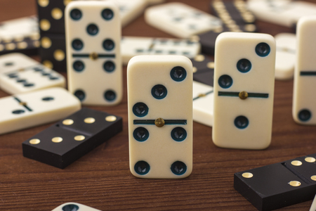 Dominoes are black and white. On a wooden background. The game is tabletopの写真素材