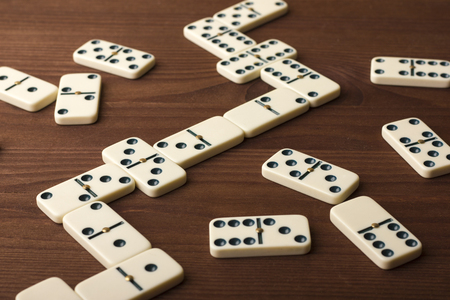 Dominoes on a wooden table. The game is tabletop. Dark backgroundの写真素材