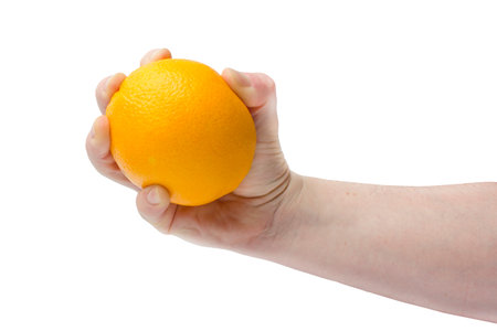 orange oranges in a hand on a white background. Isolated object の写真素材