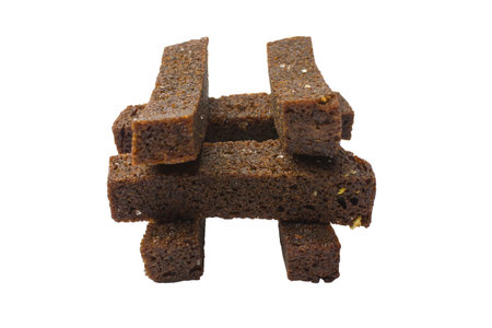 Fried garlic croutons on a white background. Black bread. Isolated