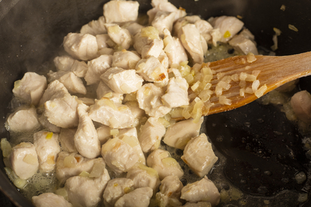 Chicken meat with onions, fried in a frying pan. Kitchen. Hot appetizing dish 1の写真素材