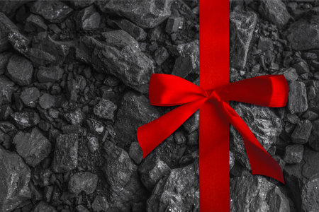 Red satin ribbon. Background, texture of coal. Copy spaceの写真素材