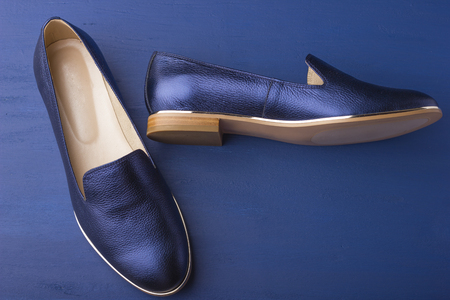 Women's shoes are dark blue on a blue backgroundの写真素材