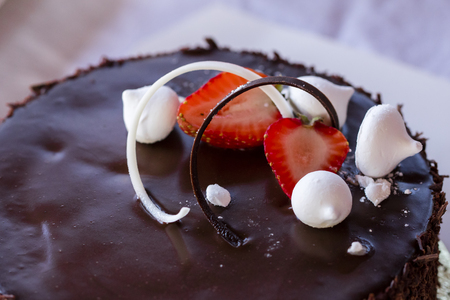 Decoration on a chocolate cake. Fresh strawberries and beziersの写真素材