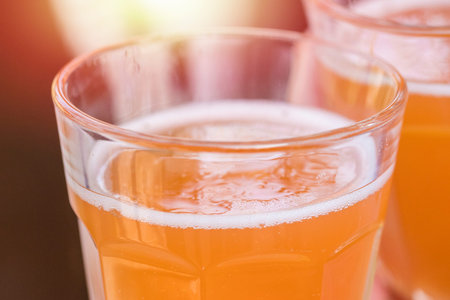 Glass with orange carbonated drink. Close-up