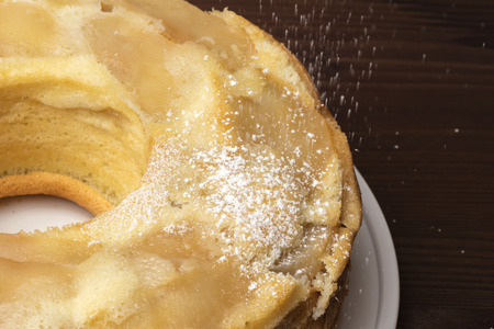 Delicious apple pie (Charlotte) sprinkled with powdered sugar. Wooden background. Close-upの写真素材