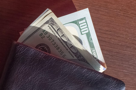 Money in the wallet is on a wooden background. The find, the loss of the wallet. View from above