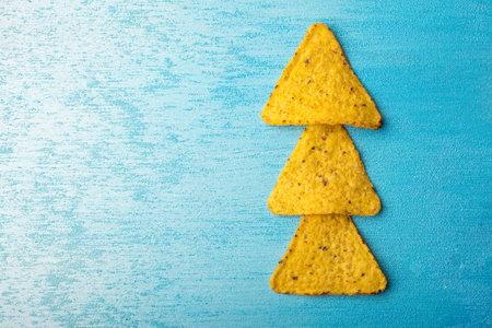 Corn tortillas with cheese. The concept of the new year from the Mexican nachos. Christmas trees...