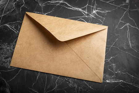 craft paper envelope on black background. Mock-upの写真素材