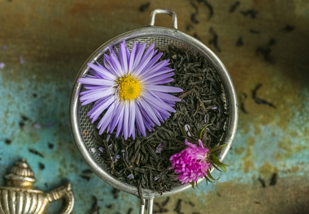 sieve with dry flower tea leaves and fresh flowers. view from aboveの写真素材