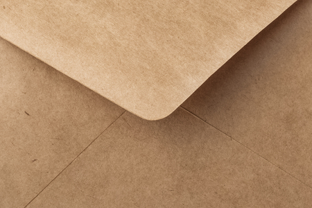 Abstract background in craft paper color. Detail envelope close up. Copy spaceの写真素材