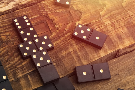 Playing dominoes on a wooden table. Domino effect. Copy spaceの写真素材
