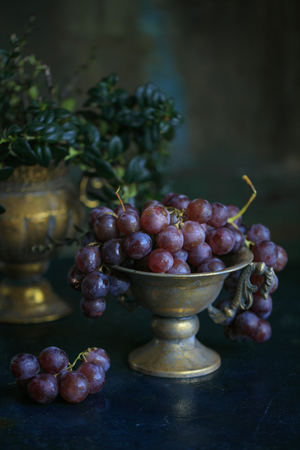 bunch of ripe grapes in a bronze bowl. Healthy food. copy spaceの写真素材
