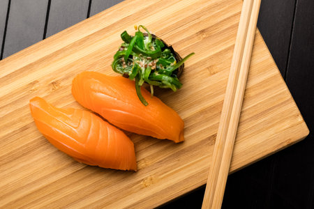 sushi with salmon on a bamboo packing board. Serving Japanese food. Top viewの写真素材