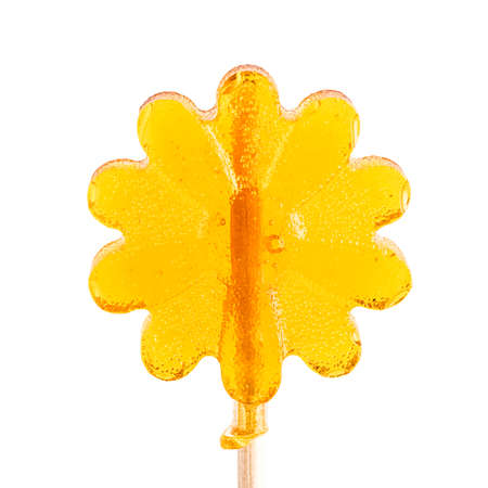Flower-shaped lollipop. Yellow lollipop on a white background. Isolated objectの写真素材