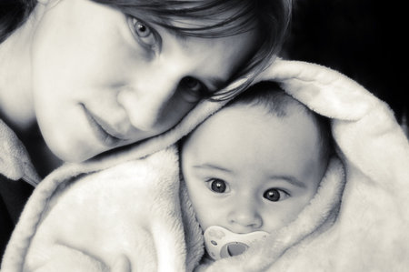 Photo of young mum and the newborn son の写真素材