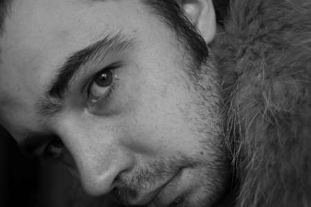 Portrait unshaven men in a jacket with a fur collar (a black-and-white photo)の写真素材