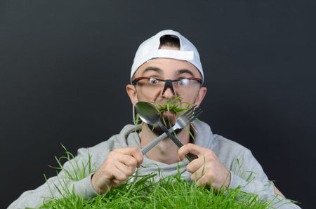 the guy eats the green grass