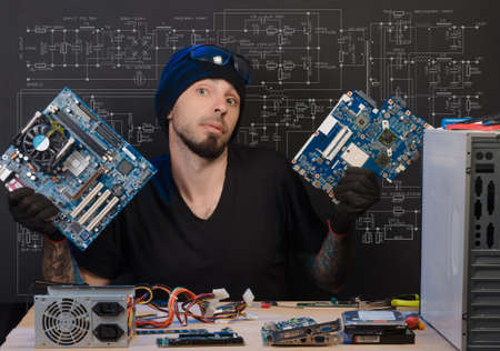 man is engaged in repair of computersの写真素材