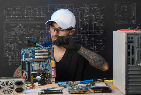 man is engaged in repair of computersの写真素材