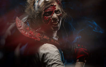 photo of the girl in zombie makeup covered in bloodの写真素材