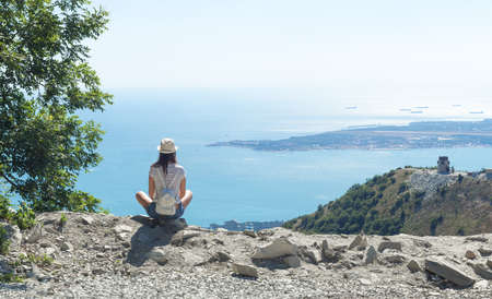 girl on the top of a mountain with sea viewsの写真素材