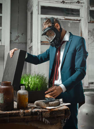 photo of man in gas mask with suitcase. in the suitcase sprouted wheatの写真素材
