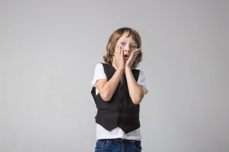child emotionally posing on camera in the Studio on a white background