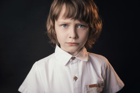 child emotionally posing on camera in the Studio on a white backgroundの写真素材