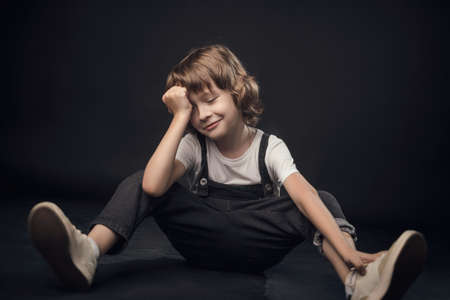 child emotionally posing on camera in the Studio on a white backgroundの写真素材