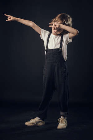 child in the Studio posing in fashionable clothesの写真素材