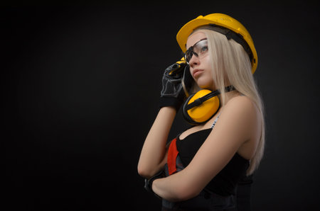 girl in a construction firm works with a tape measure