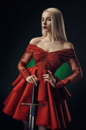 beautiful girl in red dress with swordの写真素材