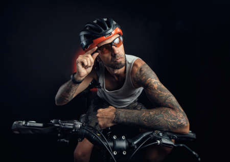 guy in a Bicycle helmet emotionally posing on a black backgroundの写真素材