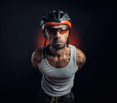 guy in a Bicycle helmet emotionally posing on a black backgroundの写真素材