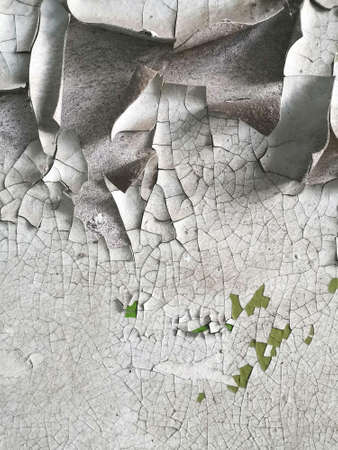 photo of an old painted wall with the texture of cracked paintの写真素材