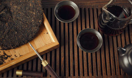 tea table with instruments teapots cups pancake and tea Shen Puerの写真素材