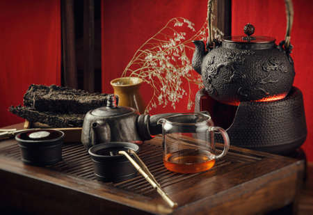the tea table with instruments teapots cups pancake and tea Shen Puerの写真素材