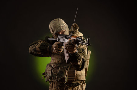 soldier militia saboteur in military clothing with a  rifle on a dark background