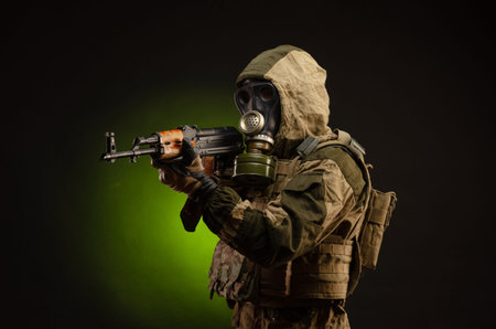 soldier Stalker saboteur in military uniform with a rifle on a dark background in a gas maskの写真素材