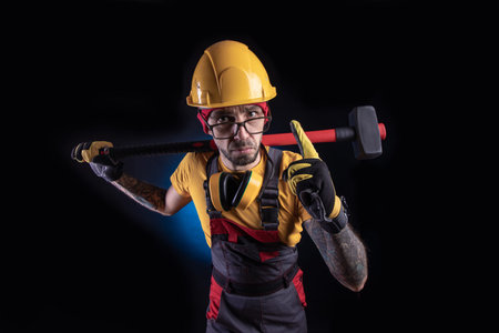 the male construction worker with a sledgehammer